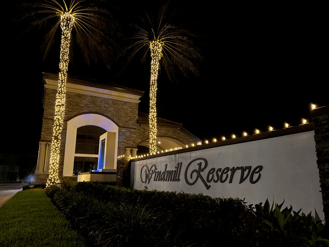 Windmill Reserve entrance sign with palm trees wrapped in lights